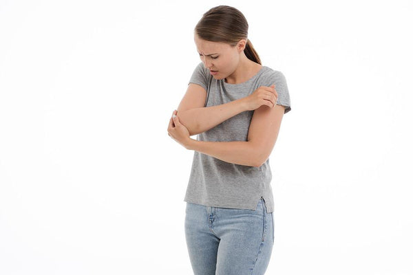 young woman experiencing elbow joint pain